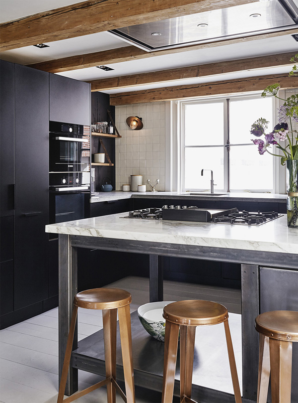 Une cuisine moderne avec des matières brutes comme de l'ardoise ou du marbre ou de l'acier. 