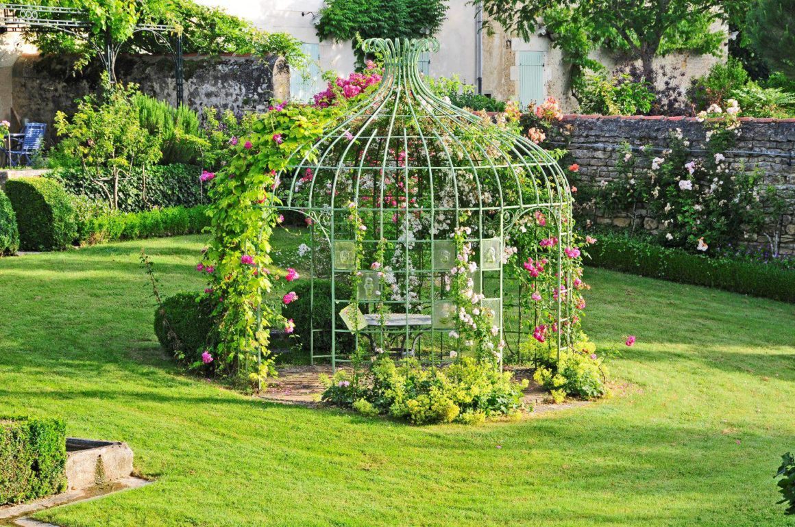 gloriette fer forgé plantes grimpantes roses jardin métal vert